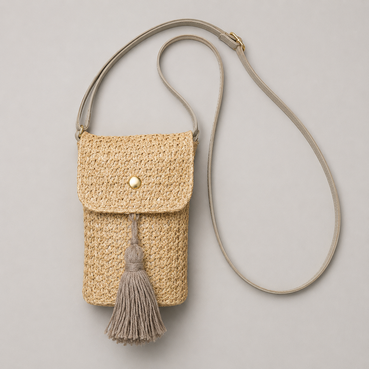 Woven straw phone crossbody bag flat lay